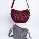 Studio shot of luxury red and gray leather handbags on a white background, showcasing elegance and style.