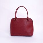 Stylish red leather handbag with handles on a clean white background, perfect for fashion enthusiasts.